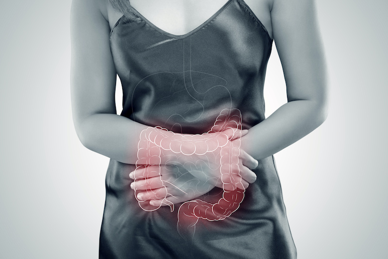 Ulcerative Colitis, The photo of large intestine is on the woman’s body against gray background, Female anatomy, Concept with healthcare and medicine